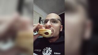 Garoto comendo um folhado de salsicha