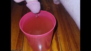 Teen fills cup with piss