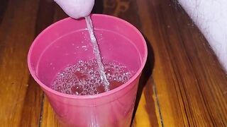 Teen fills cup with piss