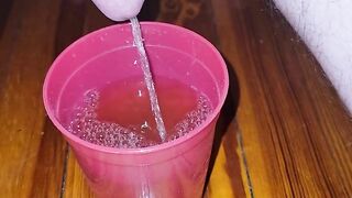 Teen fills cup with piss