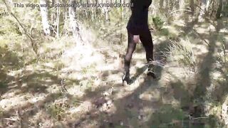 Walking on the wood wearing a black dress, pantyhose and high heels ankle boots