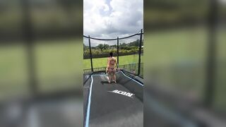 Girl in bikini jumping on trampoline. Man show style!