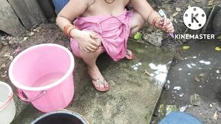 Indian house wife bathing outside