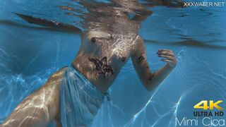 Finnish blonde tattooed pornstar Mimi underwater