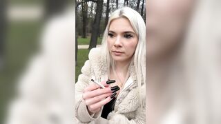 A blondie teen Nina i sitting in the park smoking and spitting making a really big spit puddle