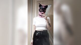 smoking girl in a pink balaclava and a cat mask