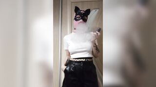 smoking girl in a pink balaclava and a cat mask