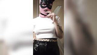 smoking girl in a pink balaclava and a cat mask